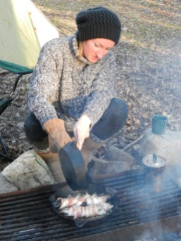 Natalia Cooking Brook Trout Wrapped in Bacon on Campfire